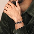 Model wearing Stainless Steel Hook Feature Braided Leather Bracelet in Black with hand on chin