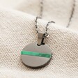 Personalised Men's Stainless Steel Green Feature Disc Pendant Necklace Showing Green Feature on Beige Fabric