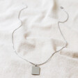 Full Chain of Men's Stainless Steel Tag Pendant Necklace on Beige Fabric