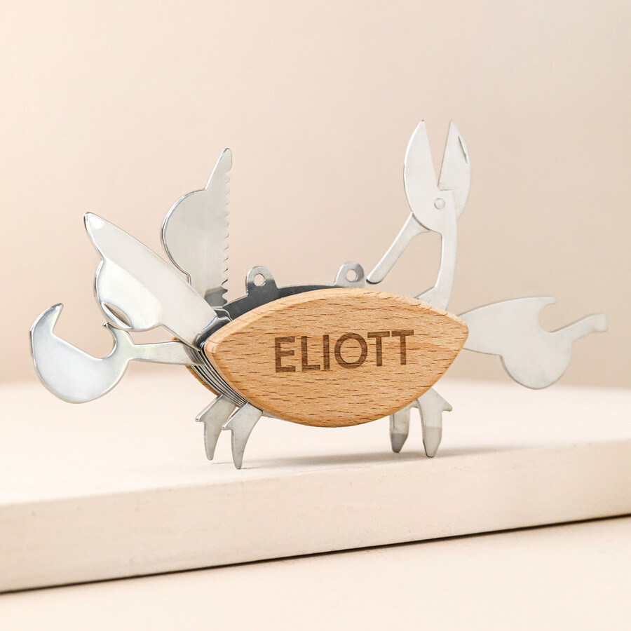 Personalised Crab Multi Tool with tools outstretched against beige coloured backdrop
