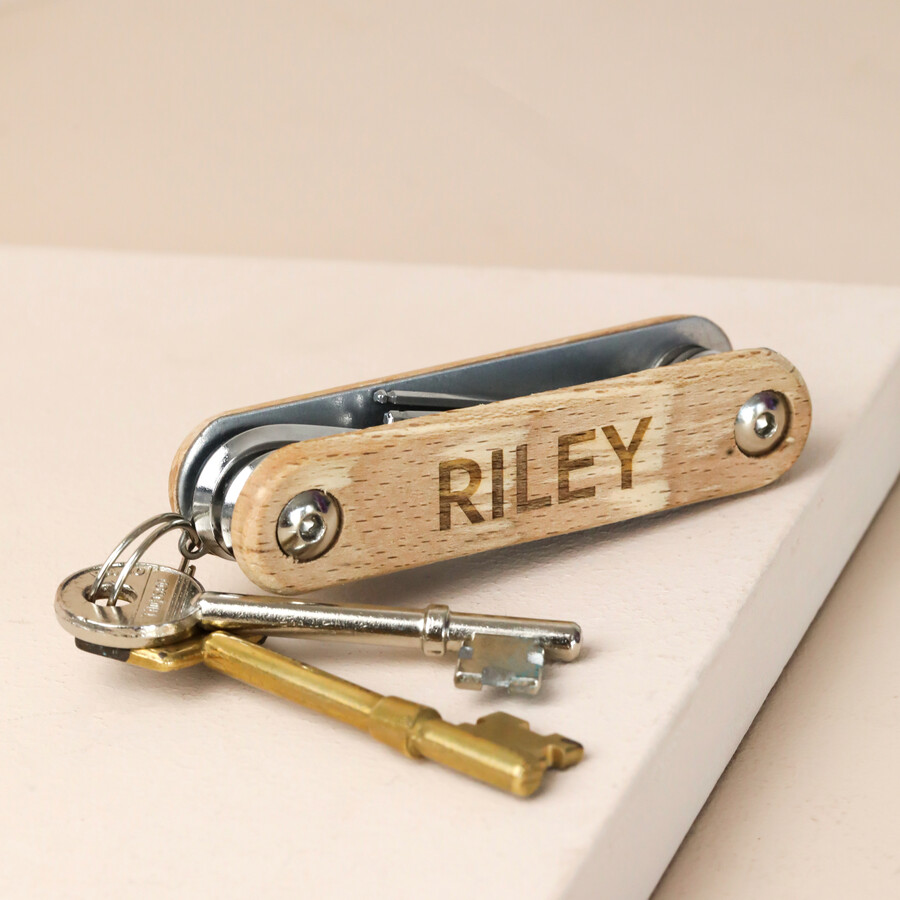 Personalised hex bike tool set attached to keys against neutral backdrop