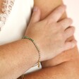 Adjustable Green Ombre Stone Bracelet in Gold on model's wrist