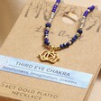 Close up of Third Eye Chakra Beaded Necklace in Gold in packaging