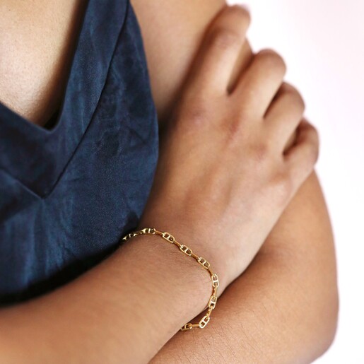 Bracelet on Model Close up of Anchor Chain Bracelet in Gold on model with hand on arm