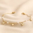 Bee, Pearl, Butterfly and Heart Charm Bracelet in Gold on Beige Fabric