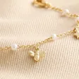 Close Up of Bee, Pearl, Butterfly and Heart Charm Bracelet in Gold