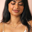 Model Wearing Bee, Pearl, Butterfly and Heart Charm Necklace in Gold