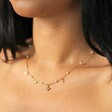 Close Up of Model Wearing Bee, Pearl, Butterfly and Heart Charm Necklace in Gold