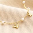 Close Up of Bee and Star Charms on Bee, Pearl, Butterfly and Heart Charm Necklace in Gold
