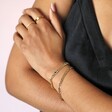 Model with Folded Arms Wearing Blue Heart Crystal Chain Bracelet in Gold