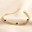Blue Heart Crystal Chain Bracelet in Gold on Beige Fabric