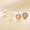 Set of Four Enamel Daisy Stud Earrings in Gold on Beige Fabric