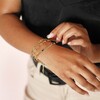 Model Wearing Green Baguette Crystal Chain Bracelet in Gold with Other Pieces