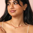 Root Chakra Beaded Necklace in Gold on model with dark hair