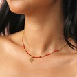 Root Chakra Beaded Necklace in Gold on model with dark hair