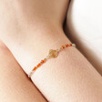 Model Wearing Root Chakra Charm Bracelet in Gold