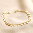 Tiny Star Charm Bracelet in Gold on Beige Fabric