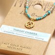 Throat Chakra Beaded Necklace in Gold on top of packaging