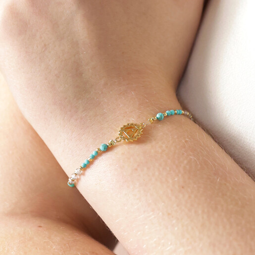 Model Wearing Throat Chakra Charm Bracelet in Gold