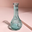 Blue Glass Posy Vase empty against neutral coloured background