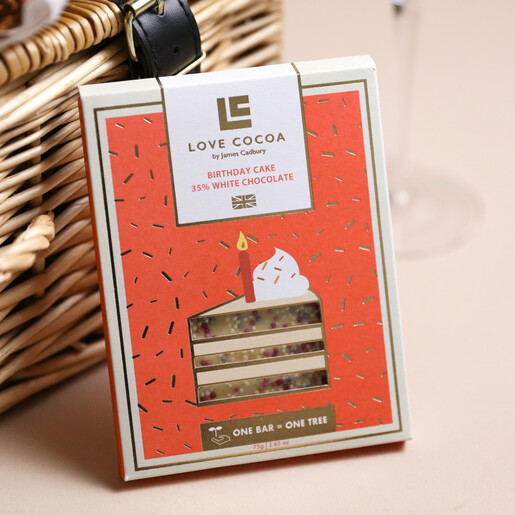 Happy Birthday Floral Wicker Gift Hamper Chocolate Bar leaning Against Wicker Basket