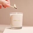 Model lighting candle from the Love You Candle and Mini Dried Flower Posy Gift