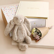 New Baby Gift Hamper With Items out of packing box on Cream surface