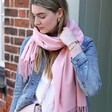 Personalised Birth Flower Pink Winter Scarf on model looking down in front of brick wall