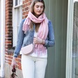 Model walking out of shop wearing Personalised Birth Flower Pink Winter Scarf with bag