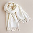 Cream Personalised Embroidered Initials Cashmere Blend Scarf twisted on plain surface