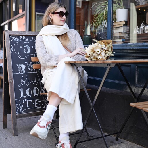 Model in sunglasses wearing the Cream Cashmere Blend Scarf
