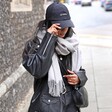 Model wearing the Light Grey Cashmere Blend Scarf over leather jacket with hat