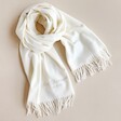 Personalised Embroidered Cashmere Blend Scarf twisted on plain surface