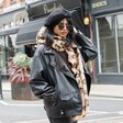 Leopard Print Winter Scarf on model in lifestyle shot walking down street with hand in hair