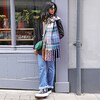 Model looking to side wearing Mustard and Blue Tartan Winter Scarf with green bag 