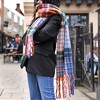 Lifestyle shot of Mustard and Blue Tartan Winter Scarf on model in street 