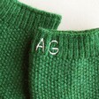 Close up of initial details on the Personalised Embroidered Hand Warmers in green