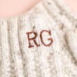 Close up of personalisation on Personalised Embroidered Knitted Hand Warmers in Marled Cream