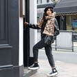 Model wearing Personalised Leopard Print Winter Scarf stepping into shop