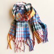 Personalised Mustard and Blue Tartan Winter Scarf arranged on neutral coloured background