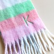 Close up of K personalisation on Personalised Pastel Bright Block Winter Scarf on top of cream backdrop