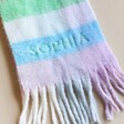 Close up of Sophia personalisation on Personalised Pastel Bright Block Winter Scarf arranged on beige background