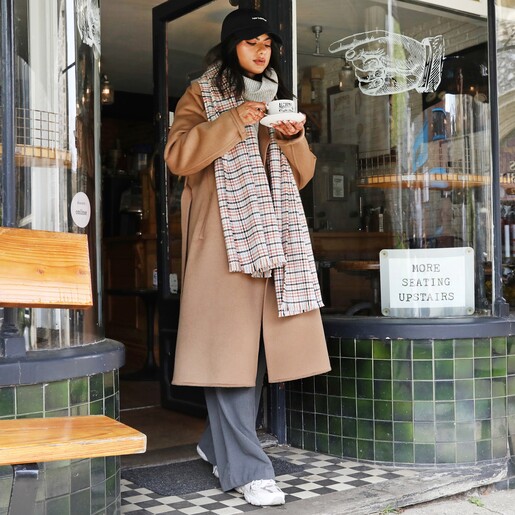 Scarf on Model Tan Tartan Winter Scarf Walking out of Shop Drinking Coffee
