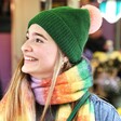 Personalised Vibrant Rainbow Striped Winter Scarf on model with green bobble hat