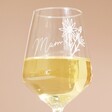 Close up of Personalised Birth Flower Wine Glass half full of white wine