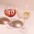 Personalised Floral Milestone Birthday Gin Glasses With 40 and 21 Personalisations on Pink Surface