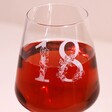Close Up of Personalised Floral Milestone Birthday Wine Glass with Rose Wine Inside 