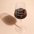 Personalised Measure Wine Glass with red wine on pink surface