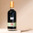 500ml The English Distillery Norfolk PX Mixed Spirit Liqueur on top of raised surface with beige backdrop