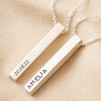 Two Personalised Sterling Silver Bar Necklaces with different personalisations on top of beige coloured fabric